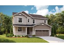 Charming two-story home with a well-manicured lawn and a two-car garage at 1351 Lumber Ridge N Cir, Erie, CO 80516