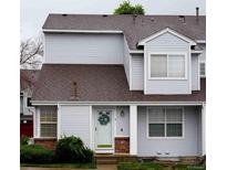 Charming townhouse exterior featuring a wreath on the door and well-maintained landscaping at 12242 Bannock Cir # D, Denver, CO 80234
