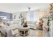 Bright living room with neutral tones, layered textures, and elegant decor at 8280 Everett Way, Arvada, CO 80005