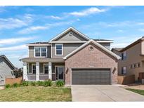 Charming two-story home featuring a welcoming front porch and a two-car garage at 3520 Desert Ridge Cir, Castle Rock, CO 80108