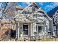 Charming home with detailed trim, a small front yard, and a cozy, welcoming entryway at 748 Elati St, Denver, CO 80204