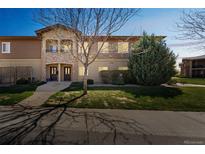 Charming townhome with well-maintained lawn, stone accents, and inviting double door entry at 2215 Calais Dr # G, Longmont, CO 80504