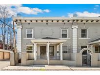Charming brick townhouse with white pillars and a welcoming front porch at 1914 E 16Th Ave, Denver, CO 80206
