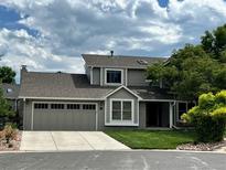 Charming two-story home with a well-maintained lawn, a two car garage, and nice curb appeal at 5 Cliffrose, Littleton, CO 80127
