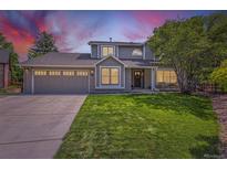 Charming two-story home featuring a well-manicured lawn, a two-car garage, and inviting curb appeal at 5 Cliffrose, Littleton, CO 80127