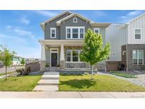 Charming two-story home with landscaped front yard and inviting porch at 20998 E 60Th Pl, Aurora, CO 80019