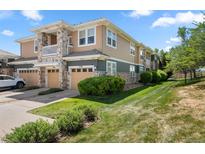 Exterior view of the property featuring the garage, lawn and stone facade at 3329 Molly Ln, Broomfield, CO 80023