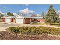 Charming brick home with a well-maintained lawn and a two-car attached garage and a detached two-car garage at 3225 Miller St, Wheat Ridge, CO 80033