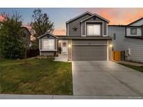 Charming home featuring a well-manicured lawn, attached garage, and beautiful exterior paint at 331 Chelsea St, Castle Rock, CO 80104