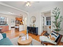 Open layout combines living spaces, showcasing the seamless integration of hardwood floors and natural light at 945 N Washington St # 201, Denver, CO 80203