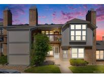 Charming two-story home featuring a brick facade, a small balcony, and a well-manicured lawn at 3090 W 107 Pl # F, Westminster, CO 80031