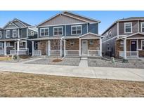 Attractive two-story home highlighting a stone facade, a welcoming porch, and a well-kept front yard at 22384 E 6Th Pl, Aurora, CO 80018
