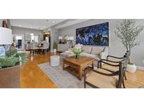 Bright and airy living room with modern decor and an open floor plan, offering a stylish and comfortable living space at 2815 W 52Nd Ave, Denver, CO 80221