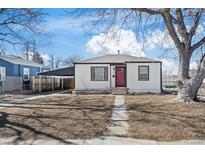 Charming single-story home featuring a red door, carport, and landscaped front yard at 4573 S Acoma St, Englewood, CO 80110