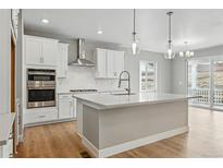 Bright eat-in kitchen featuring an island, stainless steel appliances, and lots of storage at 17196 W 92Nd Loop, Arvada, CO 80007