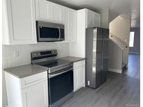 A modern kitchen with stainless steel appliances and white cabinets at 1642 N Lafayette St # 2, Denver, CO 80218
