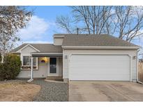Charming single-Gathering home features a two-car garage, a welcoming front door, and a well-maintained lawn at 12160 Birch St, Thornton, CO 80241
