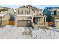 Two-story house with gray siding, stone accents, and a two-car garage at 656 N Bersshine St, Watkins, CO 80137