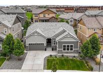 Charming single-Gathering home features neutral toned exterior, landscaped yard, and a convenient two-car attached garage at 16256 Ute Peak Way, Broomfield, CO 80023