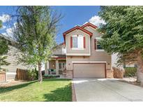 Charming two-story home featuring a well-maintained front lawn and an attached two-car garage at 4150 S Rome St, Aurora, CO 80018