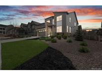 Modern home with stone accents, manicured landscaping, and an attached garage at 8290 Superior Cir, Littleton, CO 80125