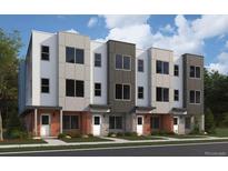 Modern townhome exterior featuring mixed materials, brick accents, and well-manicured landscaping at 15316 W 69Th Dr, Arvada, CO 80007