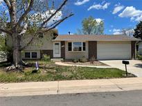 Charming home featuring a well-manicured front yard and attached two-car garage at 3062 S Florence Ct, Denver, CO 80231