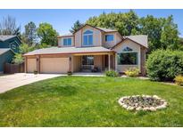 Charming two-story home with a well-manicured lawn and attached garage, perfect for suburban living at 19815 E Progress Ln, Centennial, CO 80015
