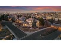 Stunning aerial view of a beautiful home in a well-developed neighborhood at dusk at 9368 S Silent Hills Dr, Lone Tree, CO 80124