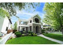 Charming home with manicured lawn, lush greenery, and inviting facade in a desirable neighborhood at 1317 S Saint Paul St, Denver, CO 80210