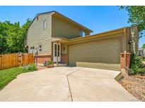Two-story home featuring an attached two-car garage and mature landscaping at 12565 Eudora St, Thornton, CO 80241