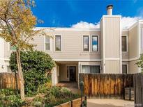 Inviting two-story townhome featuring well-maintained landscaping and a charming front yard at 1050 S Monaco Pkwy # 126, Denver, CO 80224