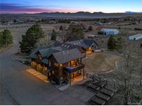 Stunning dusk view of the house, showcasing its architecture and setting within a picturesque mountain landscape at 9703 Phillips Rd, Lafayette, CO 80026
