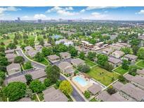 Aerial view of a well-maintained neighborhood with a community pool and green spaces at 1250 S Monaco Pkwy # 67, Denver, CO 80224