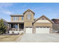 Charming two-story home with a three-car garage, covered porch, and appealing architectural details at 3493 Princeton Pl, Broomfield, CO 80023