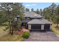 Charming two-story home featuring a three-car garage and professionally landscaped yard at 1423 Belford Ct, Evergreen, CO 80439