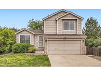 Charming two-story home with a well-maintained lawn, attached two car garage and manicured landscaping at 11864 N Chase Ct, Westminster, CO 80020