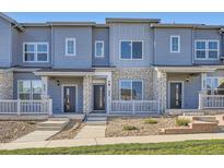Beautiful townhome featuring stone accents, covered entry, and neat landscaping at 1965 S Haleyville Way, Aurora, CO 80018
