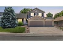 Charming two-story home with a brick-accented facade and a spacious three-car garage at 20858 E Progress Ave, Centennial, CO 80015