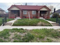 Charming brick duplex with red roof, inviting entrances, and walkways in need of some TLC at 3547 N Clayton St, Denver, CO 80205