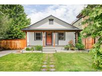 Charming single-story home with a well-manicured lawn and inviting front porch at 4421 Raleigh St, Denver, CO 80212