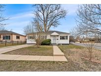 Charming single story home with mature trees and quaint front yard at 75 Vrain St, Denver, CO 80219