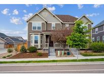 Charming two-story home featuring a well-maintained lawn, garden beds, and neutral-toned facade at 3831 E 141St Ave, Thornton, CO 80602