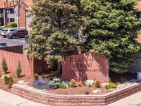 Well-maintained Telegraph Hill II Condominiums entrance with mature landscaping and signage at 12053 E Harvard Ave # 107, Aurora, CO 80014