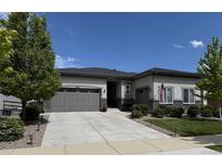 Charming ranch style home featuring a two-car garage, landscaped yard, and an inviting entrance at 26741 E Peakview Pl, Aurora, CO 80016