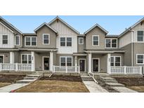 Charming townhomes featuring a modern farmhouse design and inviting front porches at 700 N Bently St, Watkins, CO 80137