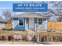 Charming blue house with a white door and a small front porch, offering curb appeal at 4846 Knox Ct, Denver, CO 80221