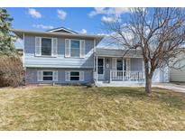 Charming two-story home featuring blue siding, white shutters, and a well-maintained front yard at 3112 S Independence Ct, Lakewood, CO 80227