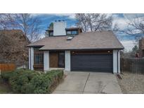 Charming two-story home features a brick chimney and a spacious two-car garage at 2822 S Uinta St, Denver, CO 80231