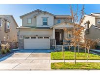 Charming two-story home with a two-car garage and well-maintained lawn on a sunny day at 13220 E 110Th Pl, Commerce City, CO 80022